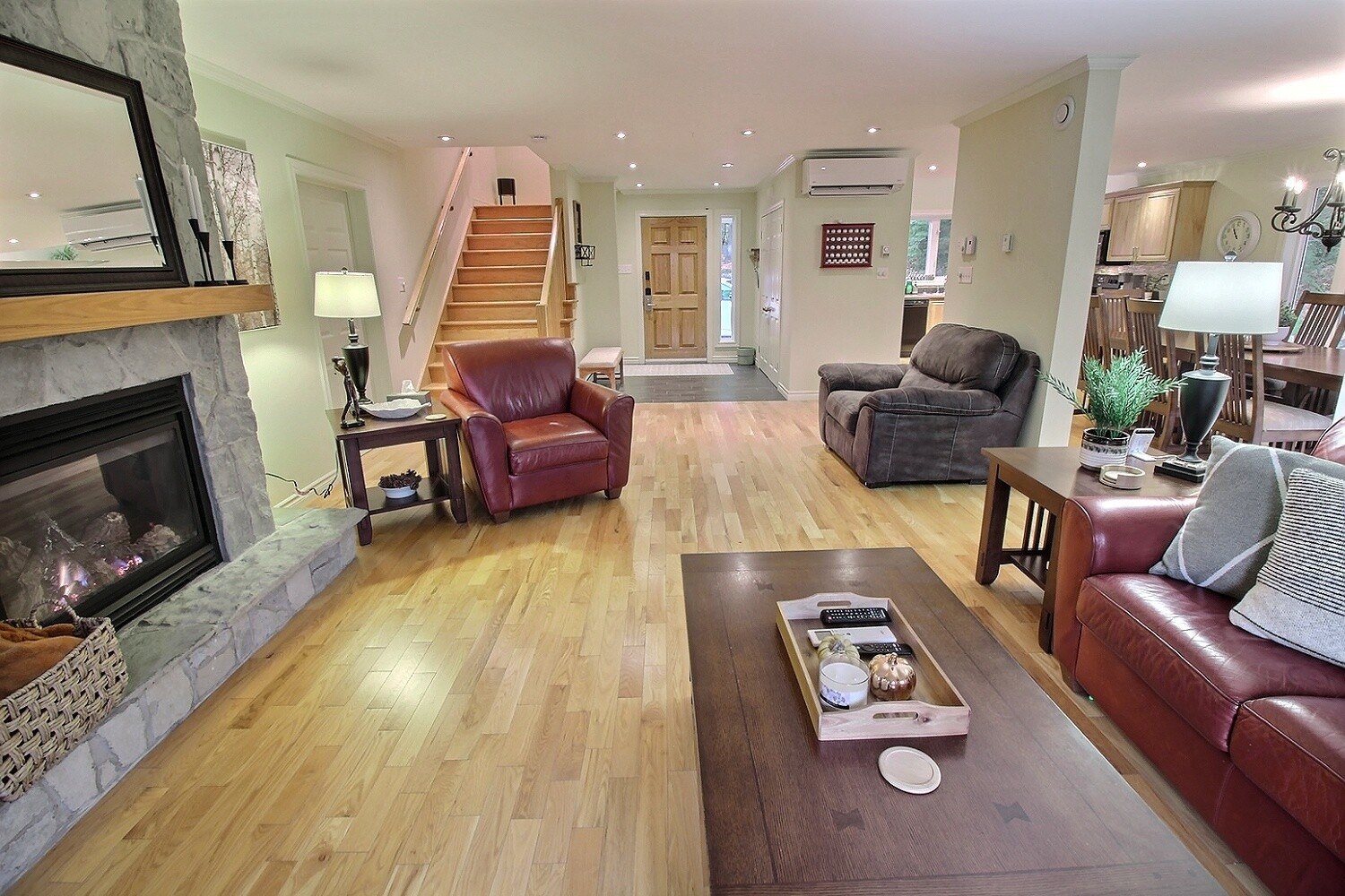 Living room with stone fireplace and leather seating